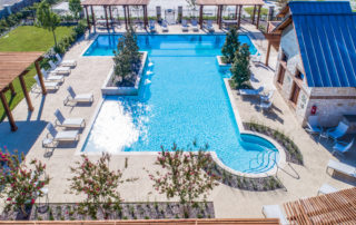 Aerial view of outdoor swimming pool with lounge chairs.