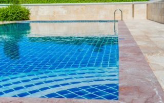 Blue water in an outdoor swimming pool.